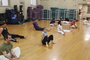 A ground of students casually stretching.
